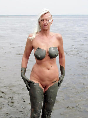 hot granny on the beach poses bared